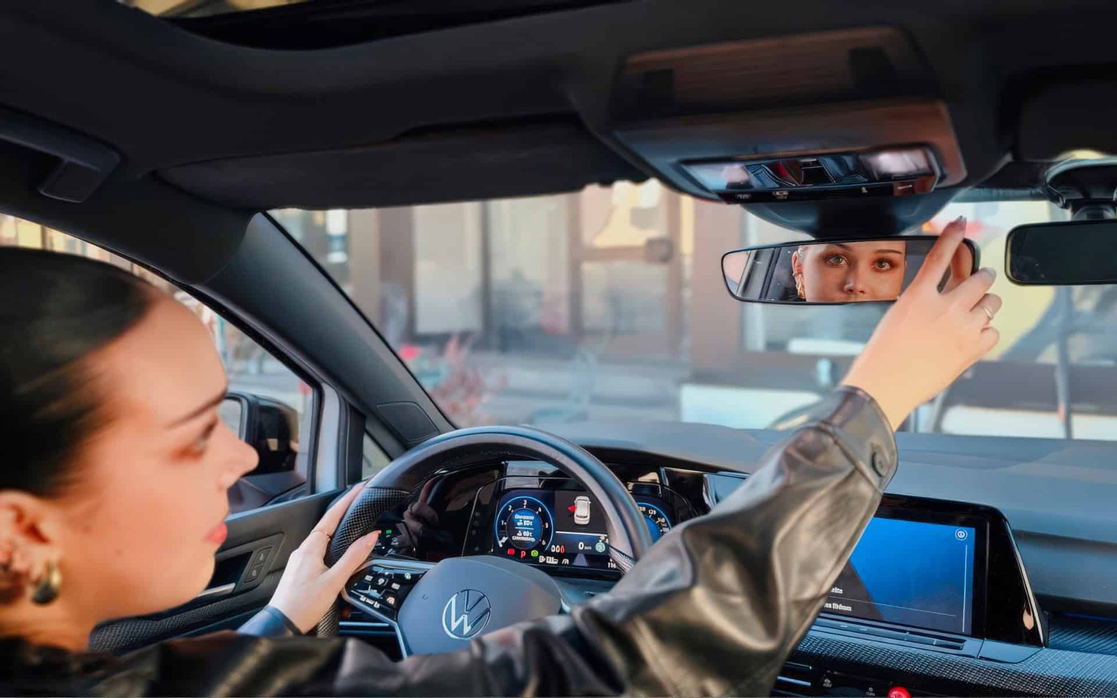 background-smiling-young-female-with-pleasant-appearance-shows-proudly-her-drivers-license-sits-new-car-being-young-inexperienced-driver.jpg
